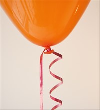 Orange balloon and ribbon.