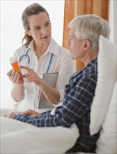 Nurse explaining prescription to senior man.
