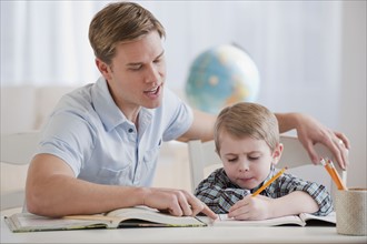 Father helping son with homework.
