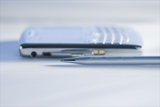 Close up of pen and electronic organizer.
