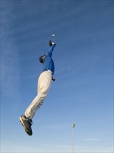 Baseball player catching ball.