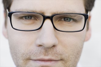 Close up of man wearing eyeglasses. Photographe : PT Images
