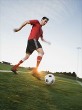 Soccer player dribbling ball.
