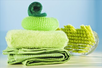 Stack of green cleaning supplies. Photographe : Daniel Grill