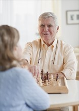 Senior couple playing chess.