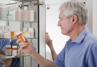 Senior man looking at prescription.
