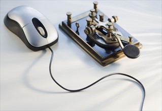 Antique telegraph key and computer mouse.