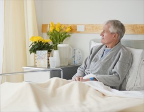 Senior man in hospital bed.