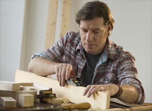 Man using woodworking tools.