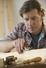 Man using woodworking tools.