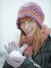 Woman packing snowball.