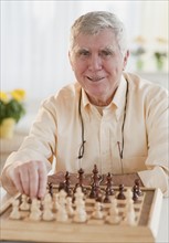 Senior man playing chess.