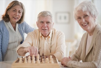 Senior adults playing chess.