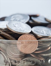 Coins in savings jar. Photographe : Jamie Grill
