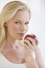 Woman eating apple. Photographe : Daniel Grill
