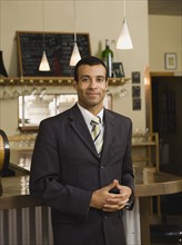 Businessman posing in restaurant.