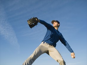 Baseball player throwing ball.