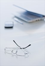Eyeglasses and laptop on desk.