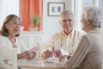 Senior adults playing cards.