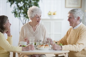 Senior adults eating dinner.
