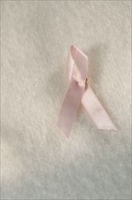 Close up of breast cancer ribbon.