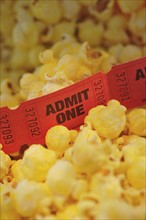 Close up of movie tickets and popcorn.