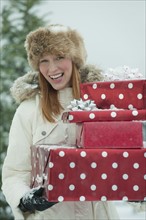 Woman carrying Christmas gifts.