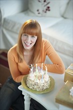 Woman celebrating birthday with cake.