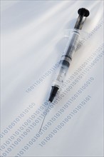 Syringe on binary code.