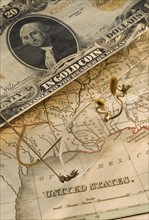 Antique map and dollar bill.