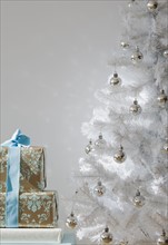 Gifts and white Christmas tree.