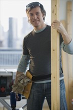 Construction worker holding board.