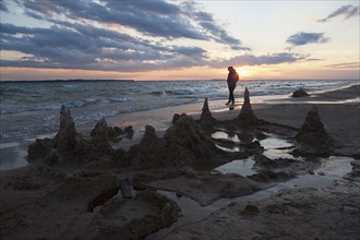 Beaver Island, Lonely person walking on beach during sunset, Beaver Island, Michigan, USA.