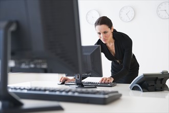 Businesswoman at work using computer.