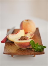 Sliced peach on chopping board.