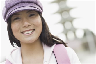 Portrait of young woman smiling, outdoors. Photographe : PT Images