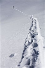 Person walking in snow up mountain, Aspen, Colorado, USA . Photographe : Shawn O'Connor