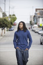 Portrait of teenage boy (16-17) walking in street, San Francisco, California, USA. Photographe : PT