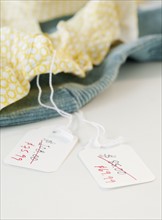 Close-up of clothing with sale tags. Photographe : Jamie Grill