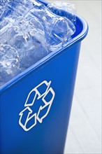 Plastic bottles in recycling bin, studio shot. Photographe : Daniel Grill