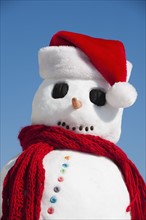 Snowman wearing Santa hat.