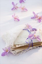 Old letters wrapped in handkerchief with flowers around.