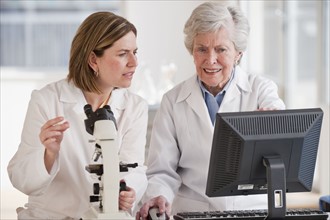 Two female scientists doing research.