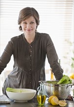 Woman preparing food in kitchen, portrait.