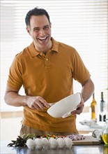 Man preparing food in kitchen.