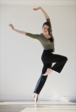 Female ballet dancer jumping, studio shot.