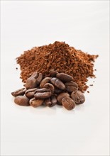 Heap of coffee beans and ground coffee.