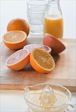 Studio shot of oranges with juicer.