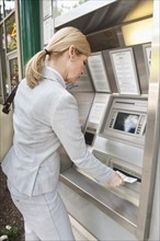 A woman at an automatic teller.