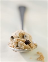 Chocolate chip cookie dough on a spoon